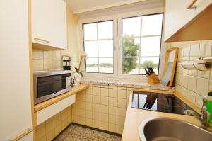 a small kitchen with a sink and a window at Narzisse in Dahme