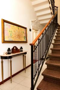 a hallway with stairs and a painting on the wall at La Casa della Zia in Milan
