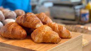 a group of croissants on a wooden cutting board at Holiday Inn Shanghai Nanjing Road by IHG in Shanghai