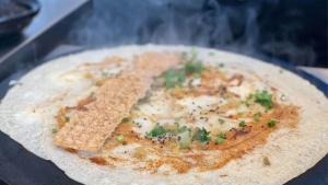 a tortilla pizza with cheese and herbs on it at Holiday Inn Shanghai Nanjing Road by IHG in Shanghai