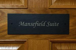 a sign on a wooden door with the word montesteadsie at Dunnet B&B Escapes in Dunnet