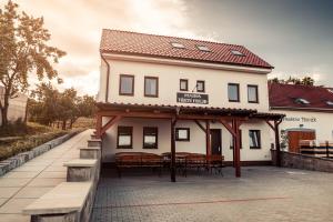 a building with tables and benches in front of it at Penzion Třetí frejd in Bořetice +16 photos