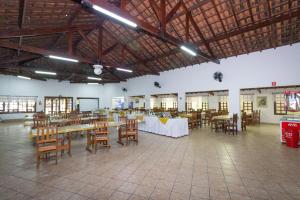 a large room with tables and chairs in it at Hotel Fazenda Pintado na Brasa in Guararema