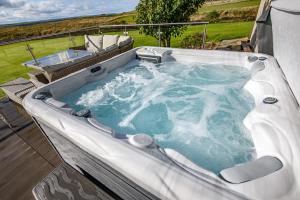 a jacuzzi tub sitting on top of a patio at Dunnet B&B Escapes in Dunnet