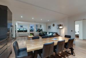 a living room and dining room with a table and chairs at Lord Street Apartments By Happy Days in Liverpool