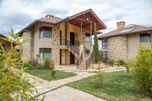 an exterior view of a house with a staircase at Elmer Resort & Spa Naivasha in Naivasha