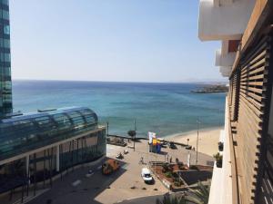 a view of a beach and the ocean from a building at CITY&SEA in Arrecife