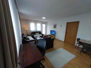 a living room with a couch and a table at City View - Downtown Apartment in Prishtina in Pristina