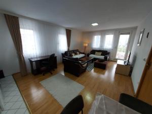 a living room with a couch and a table at City View - Downtown Apartment in Prishtina in Pristina