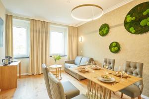 a living room with a table and a couch at Green Leisure Apartments Schweglerstrasse in Vienna
