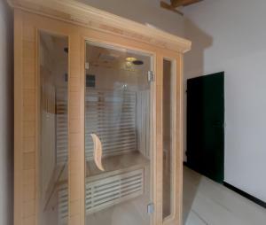 a wooden cabinet with a window in a room at Notte Rosa Suites & Relax in Fornovo di Taro