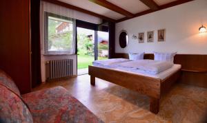 a bedroom with two beds and a window at Landhaus Birgit in Telfes im Stubai