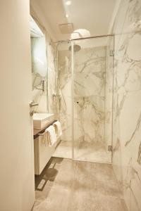 a bathroom with a shower and a sink at Green Leisure Apartments Schweglerstrasse in Vienna +51 photos