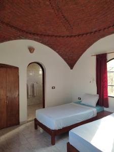 A bed or beds in a room at Nubian Holiday House Aswan