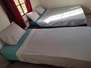 A bed or beds in a room at Nubian Holiday House Aswan