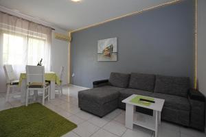 a living room with a couch and a table at Apartments Zeljko in Pag