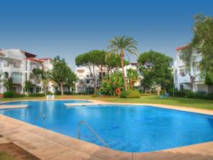 a large swimming pool in front of some apartments at Sun Beach Apartment in Estepona