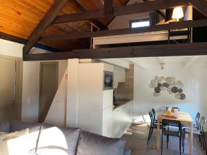 a living room with a couch and a table with chairs at vakantiehuisje 003 in Koksijde