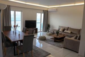 a living room with a table and a couch at Superior Double Room with Stunning Sea View. DT in Patra