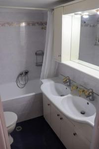 a white bathroom with a sink and a toilet at Superior Double Room with Stunning Sea View. DT in Patra