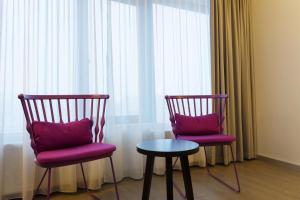 two chairs and a table in front of a window at Scandic Narvik in Narvik