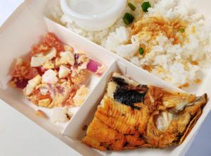 a box of food with rice and a piece of fish at RedDoorz @ Walk Inn Hotel in Manila