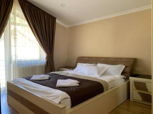 Postel nebo postele na pokoji v ubytování Villa Astoria Bakuriani