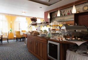 a kitchen with a counter and a table with chairs at Central Boutique Hotel in Bad Mergentheim