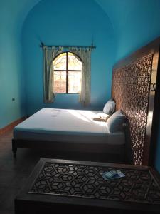 A bed or beds in a room at Nubian Holiday House Aswan