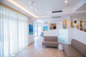 a living room with a white counter and a couch at Hotel Baby in Rimini