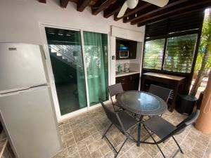 cocina con mesa, sillas y nevera en Chacala Arrecifes 1 para 2 con Aire Acondicionado a solo 50 mts de la Playa ARF1, en Chacala