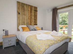 a bedroom with a bed with towels on it at Stall 2 - The Stables in Truro