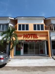 a hotel with a palm tree in front of it at RELAX HOTEL in Sungai Petani