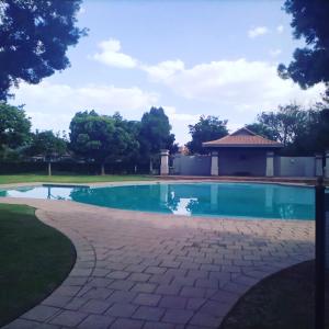 a swimming pool in a yard with a gazebo at Pecanwood Home Away from Home in Hartbeespoort