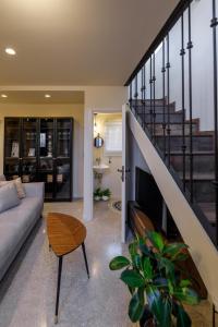 a living room with a couch and a staircase at Spitaki by the sea in Kos