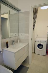a bathroom with a sink and a washing machine at Sunrise Apartment in Santa Margherita Ligure