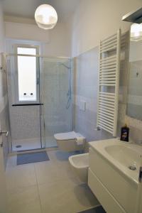 a bathroom with a toilet and a sink and a shower at Sunrise Apartment in Santa Margherita Ligure