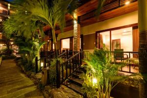 a house with a balcony with plants and lights at Qualia Resort Phu Quoc in Phú Quốc