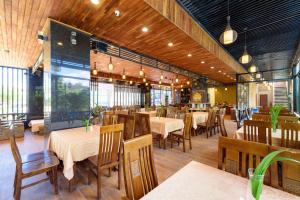 a dining room with tables and chairs in a restaurant at Qualia Resort Phu Quoc in Phú Quốc