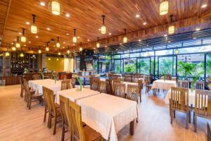 a dining room with tables and chairs in a restaurant at Qualia Resort Phu Quoc in Phú Quốc