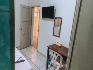 a room with a table and a mirror and a door at Hotel América in Recife +13 photos