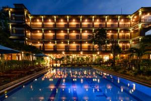 a hotel with a swimming pool at night at Qualia Resort Phu Quoc in Phú Quốc