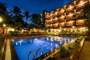 a hotel with a swimming pool at night at Qualia Resort Phu Quoc in Phú Quốc