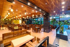 a restaurant with wooden tables and chairs and a cafeteria at Qualia Resort Phu Quoc in Phú Quốc