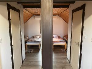 A bed or beds in a room at Perényi Pince és Vendégház Hajós