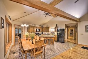 a kitchen with a wooden table and a dining room at Peaceful and Secluded Home with Private Fire Pit! in Rising Fawn