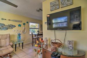 a living room with a flat screen tv on the wall at Comfy Dunedin Escape 1 Block to Main Street! in Dunedin