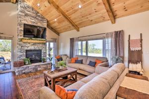 a living room with a couch and a fireplace at Chic Williamstown Retreat with Pool and Hot Tub! in Williamstown