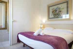 a hotel room with two beds and a picture on the wall at Apartamentos Calvet in Barcelona