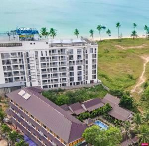 an aerial view of a large building with palm trees at Qualia Resort Phu Quoc in Phú Quốc